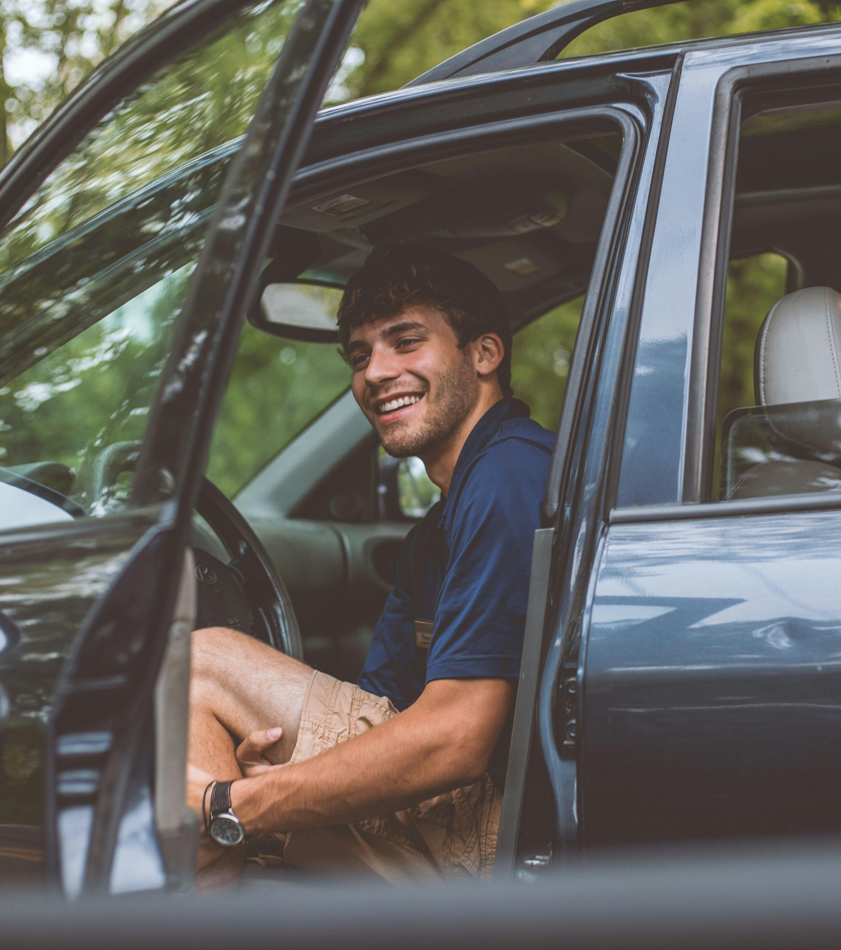 Person smiling while parked in their car